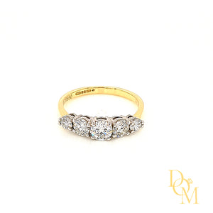 Five stone diamond ring with 5 round diamonds, graduating in size and each in a four claw setting. White setting & yellow band