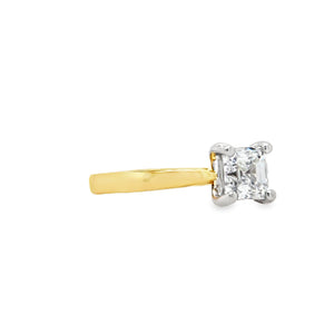 Two-tone gold ring with an asscher-cut diamond in a four claw, white gold setting and yellow shank on a white background