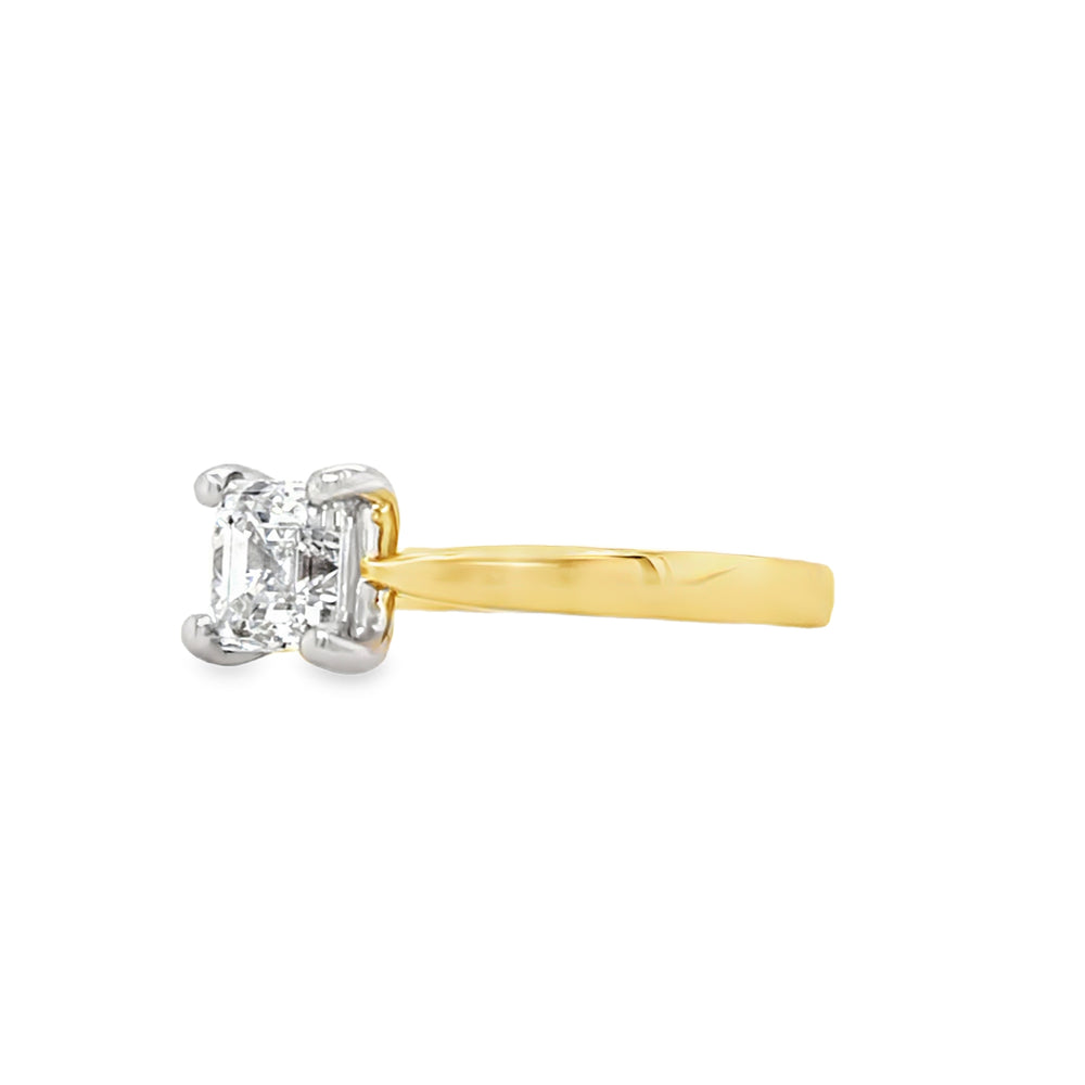 Two-tone gold ring with an asscher-cut diamond in a four claw, white gold setting and yellow shank on a white background