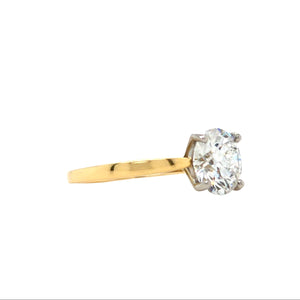 Round brilliant-cut lab grown diamond in a four claw platinum setting with a slightly tapered 18ctyellow gold band