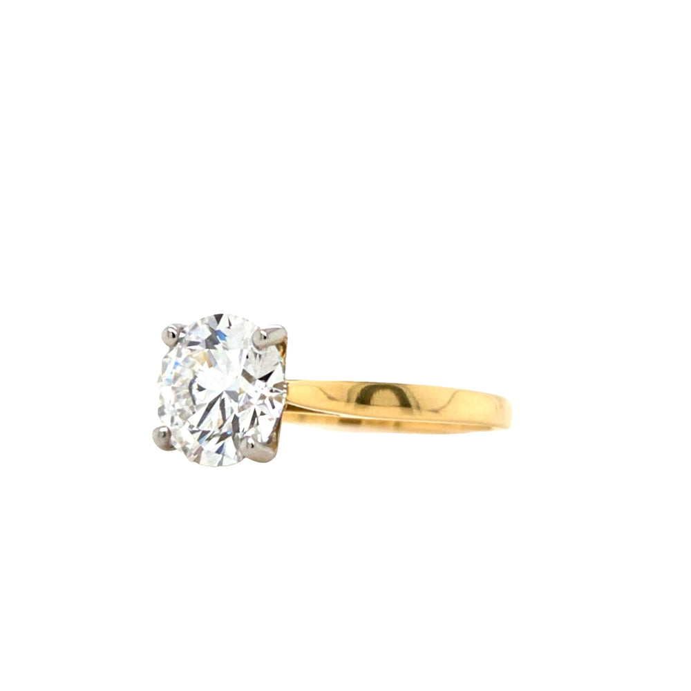 Round brilliant-cut lab grown diamond in a four claw platinum setting with a slightly tapered 18ctyellow gold band