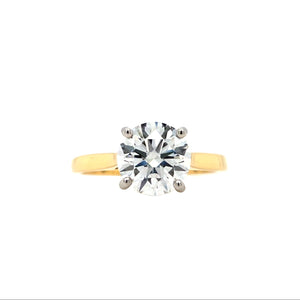 Round brilliant-cut lab grown diamond in a four claw platinum setting with a slightly tapered 18ctyellow gold band