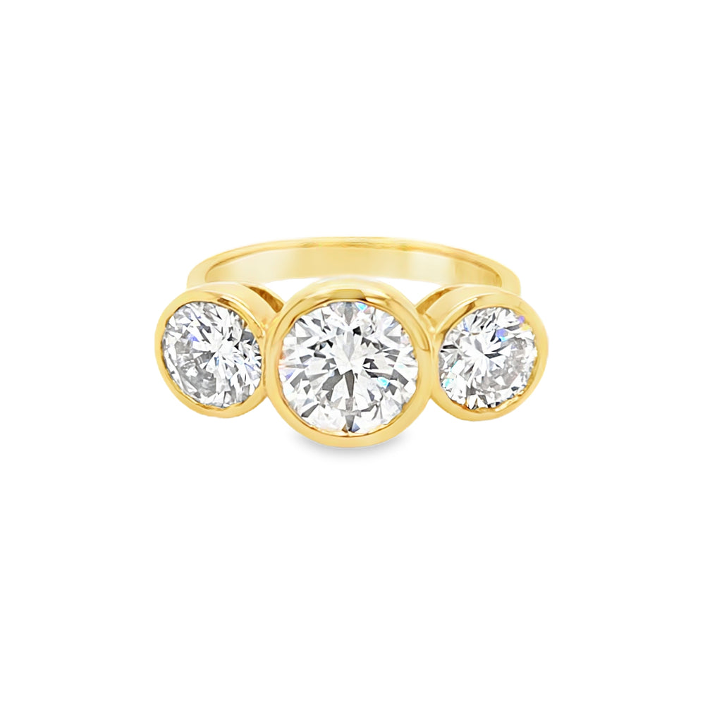 Front view of 18ct yellow gold three stone engagement ring with bezel set lab grown diamonds.