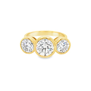 Front view of 18ct yellow gold three stone engagement ring with bezel set lab grown diamonds.