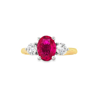 18ct yellow gold and platinum three-stone ring featuring an oval lab grown ruby with round brilliant lab diamond sides on white background.