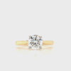Round brilliant cut diamond in a four claw setting with a yellow gold tapered shank