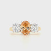Three stone oval lab grown diamond engagement ring with fancy orange centre diamond and white setting in 18ct yellow gold