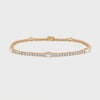 Gold tennis bracelet with oval lab grown diamonds and round lab grown diamonds on a white background