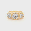 18ct yellow gold three stone engagement ring with bezel set lab grown diamonds.