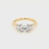 Three graduating round brilliant-cut lab grown diamonds, each in a four claw platinum setting with a slim 18ct yellow gold shank.