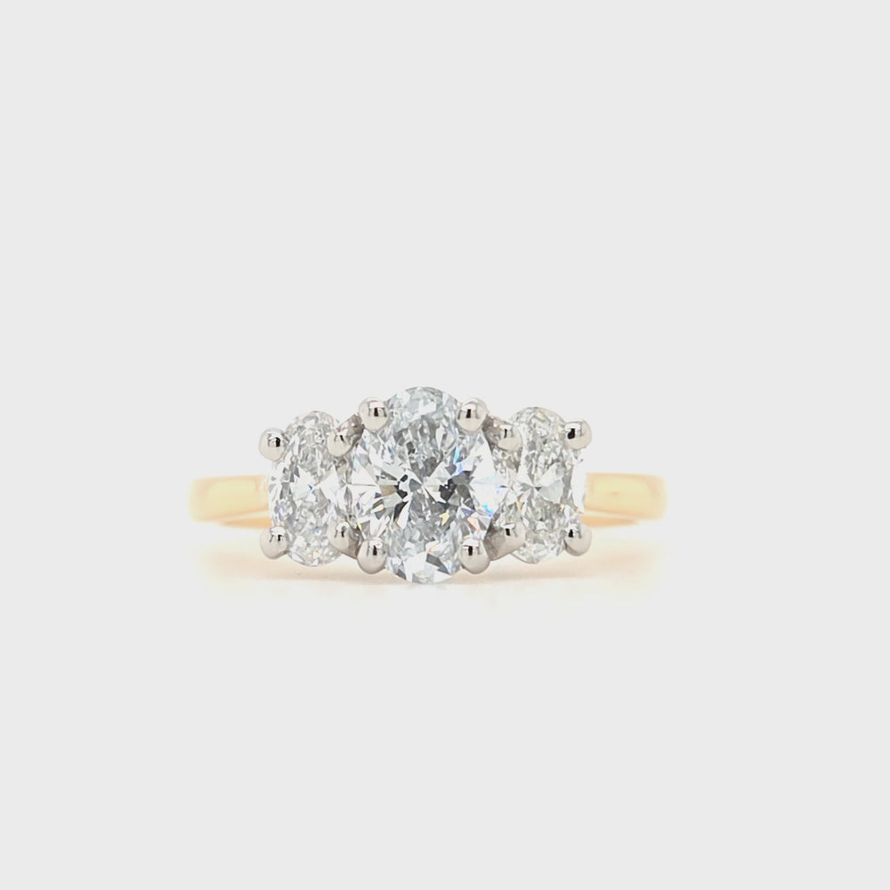 
                
                    Load and play video in Gallery viewer, Three oval-cut lab grown diamonds each in a four claw platinum setting with a tapered yellow shank
                
            