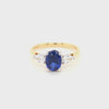 18ct gold and platinum lab grown sapphire and diamond ring showing four-claw sapphire mount and three-claw pear diamond settings.
