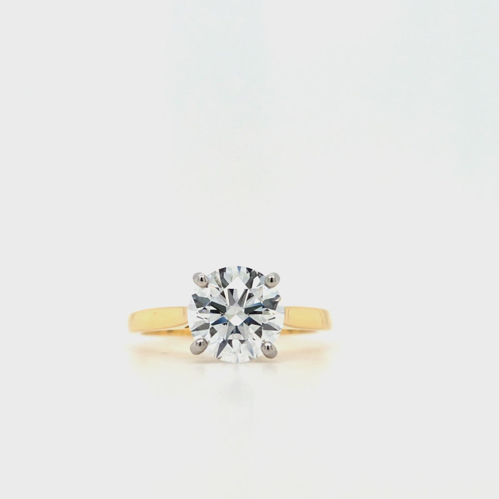 
                
                    Load and play video in Gallery viewer, Round brilliant-cut lab grown diamond in a four claw platinum setting with a slightly tapered 18ctyellow gold band
                
            
