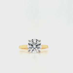 
                
                    Load and play video in Gallery viewer, Round brilliant-cut lab grown diamond in a four claw platinum setting with a slightly tapered 18ctyellow gold band
                
            