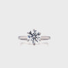 A round lab grown diamond, set in a six claw setting with a plain, slim shank.