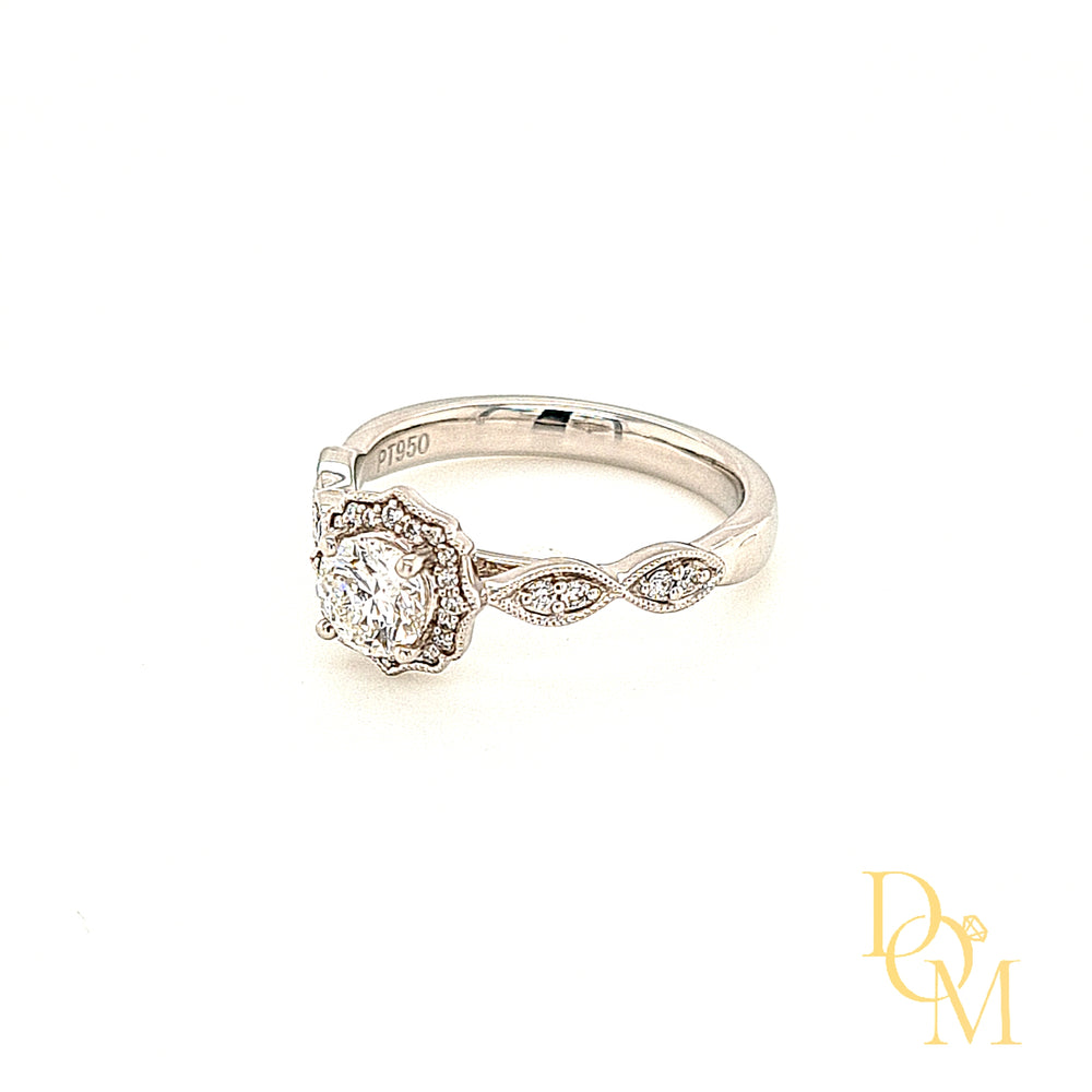 Platinum Halo Cluster Engagement Ring with round centre in a four claw setting. The surrounding cluster has a scalloped edge with millegrain decoration. Each shoulder features marquise shaped diamond settings