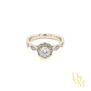 Platinum Halo Cluster Engagement Ring with round centre in a four claw setting. The surrounding cluster has a scalloped edge with millegrain decoration. Each shoulder features marquise shaped diamond settings
